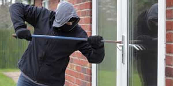 Burglar trying to open a door
