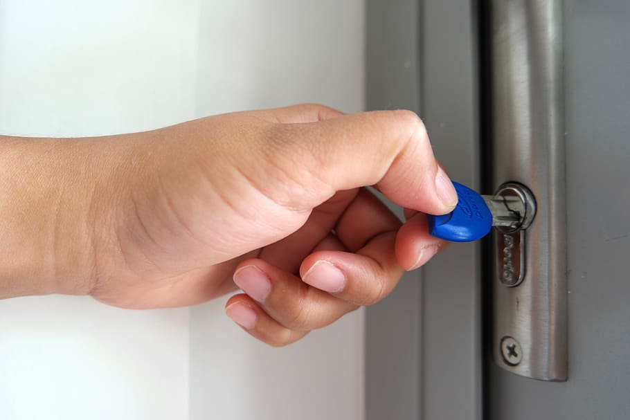 Blue key opening a Lock